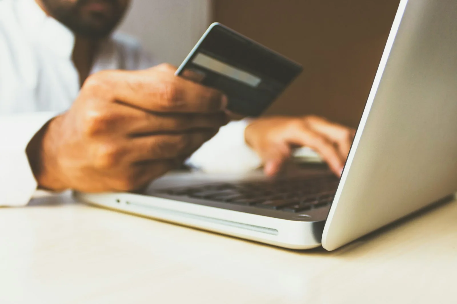 Paying with a card while working at a laptop